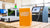 Orange box labeled 'LASER START' with laser engraving equipment in a workshop.