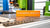 Close-up of SLM Metal Printing sign on a manufacturing machine table in a workshop.